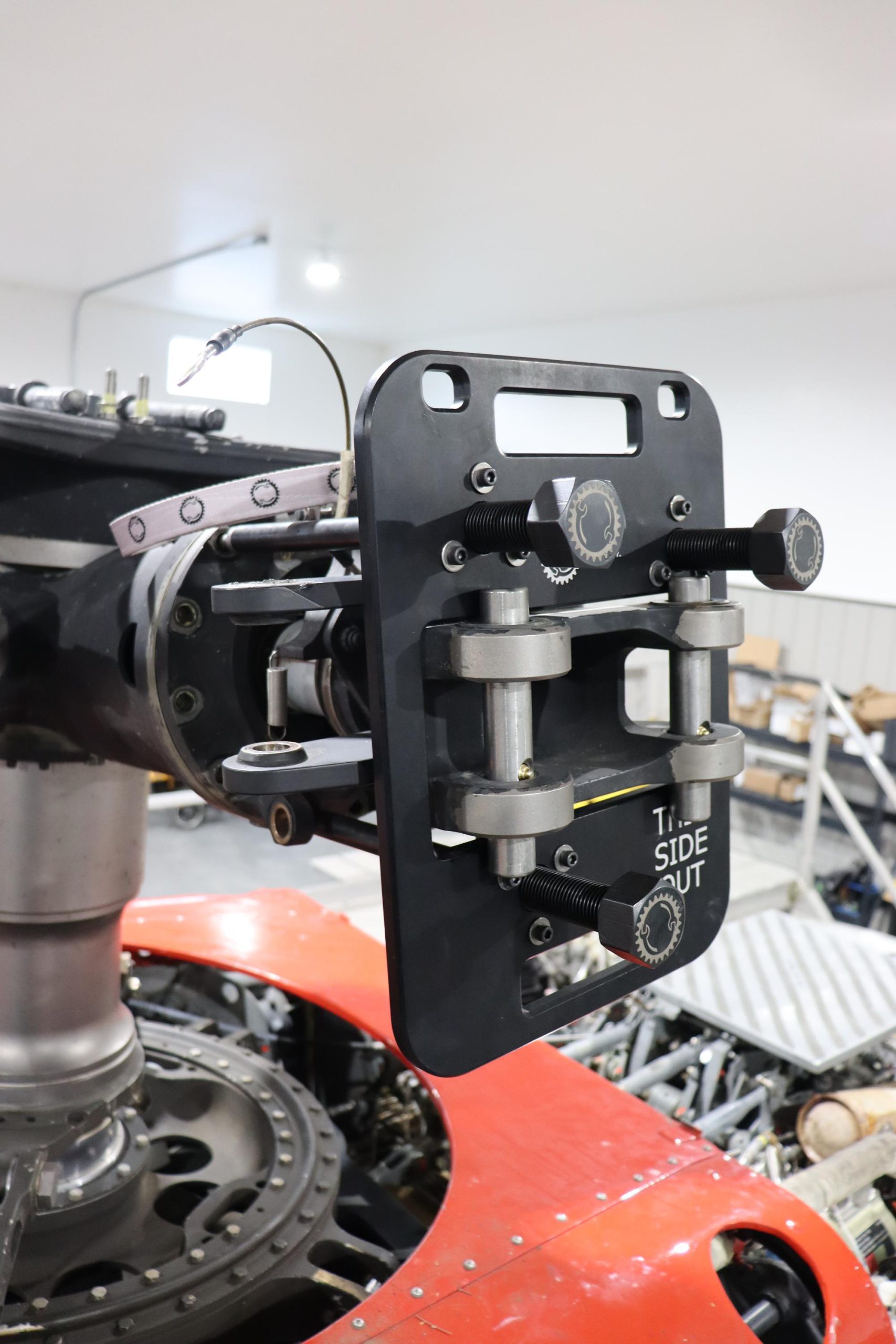 H-60 Blackhawk Main Rotor Spindle Extractor Spindle Extractor HMR-SPEX-1 SP-60-AA Spindle Puller for UH-60 A/L/M The H60 Main Rotor Blade (SP-60-AA) Spindle Puller is used to effectively pull the spindle free from the Main Rotor Hub Assembly. As a one-person task, it is designed to control the removal of the spindle, even if stuck due to corrosion or abrasion. Every Spindle Puller is delivered in a Pelican case with custom MIL-spec foam cushioning, allowing for easy and safe transportation or storage. The Spindle Puller is comprised of a single base plate with three ACME driver assemblies threaded to hex nut holders that push against the main rotor hub. The driver assembly rods have driver feet that allow to for self-articulation and adjustment when pushing against the hub. Spindle stainless steel cross pins with retaining plungers are inserted into the main rotor blade cuff lugs allowing the tool to safely pull the spindle free from the hub as it pushes against the base plate. A safety retention nylon webbing attached to the spindle plate, using a safety retainer puck inserted into the hub spindle inspection port, catches the spindle once it is freed, preventing it from being dropped.